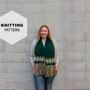 May include: A woman wearing a green and gold knitted scarf with fringe. The scarf has a diamond pattern. The text "Knitting Pattern" is in a white hexagon.
