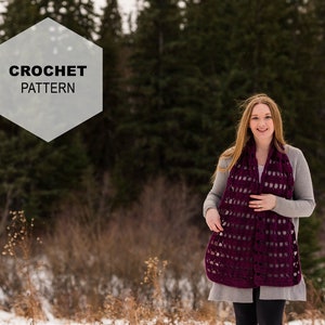 May include: A burgundy crochet scarf with a geometric openwork design is worn over a grey sweater. The text "CROCHET PATTERN" is displayed in a white hexagon shape. The background is a snowy landscape with evergreen trees.