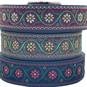May include: Three rolls of burgundy, green and black patterned trim with a floral design. The trim has a scalloped edge.