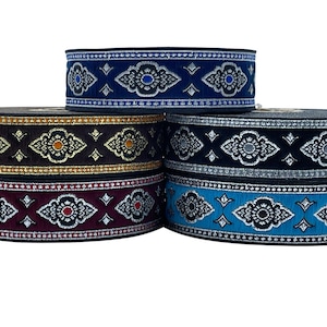 May include: Five spools of black fabric trim with silver and gold embroidery. The trim features a repeating pattern of stylised flowers and diamonds.