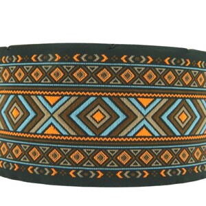 May include: A black fabric band with a geometric pattern in orange, blue, and brown. The pattern is made up of diamonds, triangles, and zigzags.
