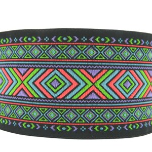 May include: Black fabric trim with a colorful geometric pattern in shades of green, blue, pink, and purple. The pattern features repeating diamonds and triangles.