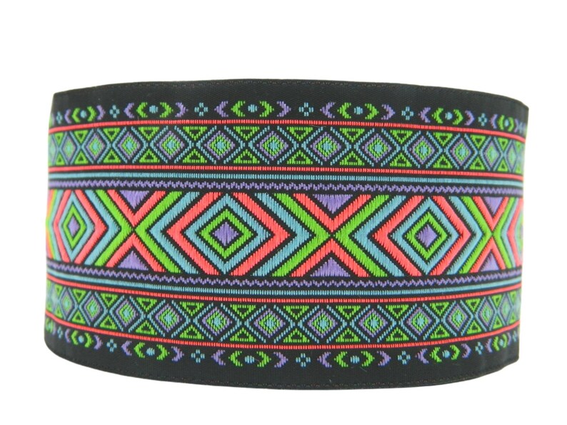 May include: Black fabric trim with a colorful geometric pattern in shades of green, blue, pink, and purple. The pattern features repeating diamonds and triangles.