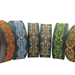 May include: Six spools of black ribbon with colourful embroidered designs. The designs feature intricate floral patterns in shades of orange, pink, blue, green, and brown.