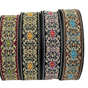 May include: Four rolls of black trim with colourful floral patterns. The trim has a scalloped edge and is made of woven fabric.