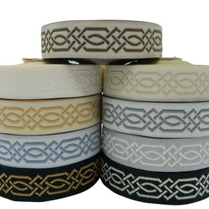 May include: A selection of decorative ribbon rolls in shades of cream, gold, grey, and black. Each roll displays an embroidered geometric pattern. These ribbons are suitable for crafts or decorative purposes.