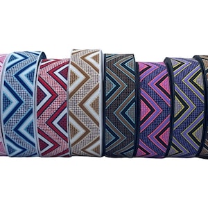 Pode incluir: Conjunto de oito elásticos coloridos com um padrão geométrico chevron. As elásticas são rosa, azul, vermelho, castanho, preto, roxo e amarelo.