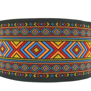 May include: Black fabric trim with a colorful geometric pattern featuring red, orange, blue, and yellow diamonds. The pattern is repeated along the length of the trim.