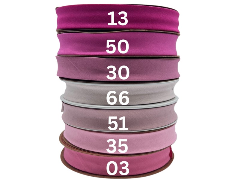 May include: A stack of seven pink and purple fabric ribbon rolls with numbers 13, 50, 30, 66, 51, 35, and 03 printed on them.