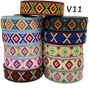 May include: A collection of patterned ribbons in a variety of colours, labelled V1 to V11. The top ribbon is black with orange, green, and pink geometric designs. Other ribbons display blue, brown, red, and white patterns.