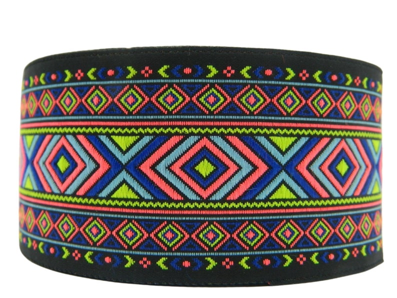 May include: Black fabric trim with a colorful geometric pattern in shades of blue, green, pink, and yellow. The pattern features repeating diamond shapes and zigzags.