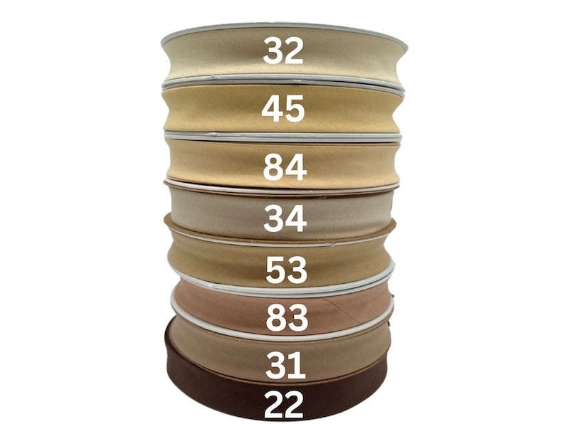 May include: A stack of eight beige and brown fabric ribbon rolls with numbers printed on each roll: 32, 45, 84, 34, 53, 83, 31, and 22.