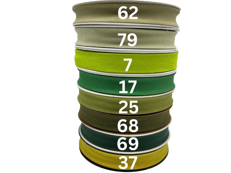 May include: A stack of eight green, yellow, and brown fabric ribbon rolls with numbers printed on each roll. The numbers are 62, 79, 7, 17, 25, 68, 69, and 37.