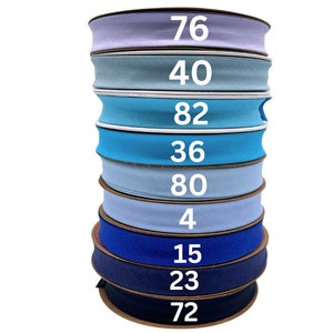 May include: A stack of ten rolls of blue and light blue elastic fabric with numbers printed on each roll. The numbers are 76, 40, 82, 36, 80, 4, 15, 23, and 72.
