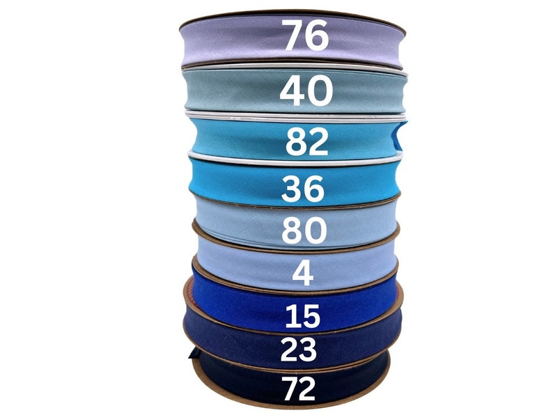 May include: A stack of ten rolls of blue and light blue elastic fabric with numbers printed on each roll. The numbers are 76, 40, 82, 36, 80, 4, 15, 23, and 72.