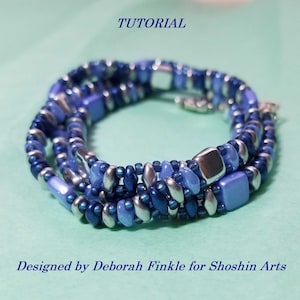 May include: A multi-strand bracelet made with blue and silver beads. The bracelet is wrapped around itself to form a circle. The bracelet is on a light blue background. The text "TUTORIAL" is at the top of the image. The text "Designed by Deborah Finkle for Shoshin Arts" is at the bottom of the image.