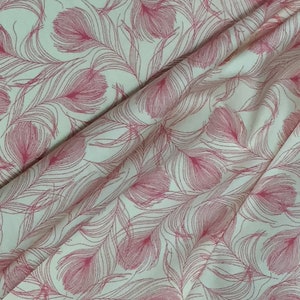 May include: White fabric with a pink feather pattern. The fabric has a subtle sheen and a soft texture.