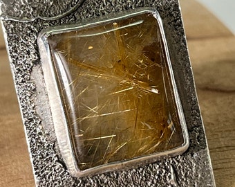 Fascinating size 7 Ring - Rutilated Quartz Crystal framed in sterling silver.