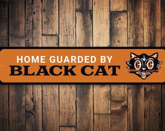 May include: Orange and black metal sign with the text "HOME GUARDED BY BLACK CAT" and a black cat with white eyes and a wide open mouth.