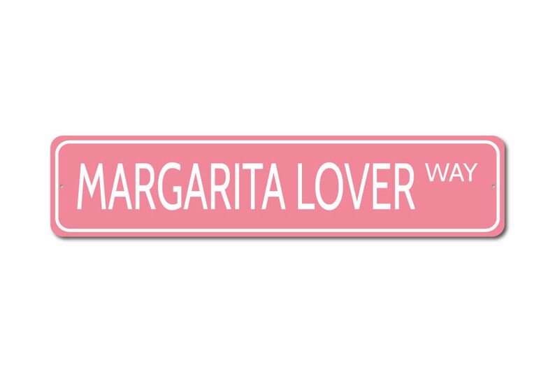 May include: Pink metal sign with white text that reads "Margarita Lover Way".