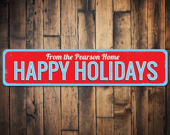 May include: A red and blue sign with the text "From the Pearson Home Happy Holidays" on a wood background.