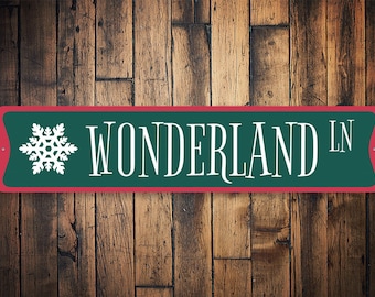 May include: A green and red metal sign with a white snowflake and the text "WONDERLAND LN".