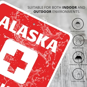 a red and white sign that says alaska on it