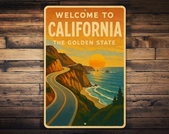 May include: Vintage-style metal sign with the text "WELCOME TO CALIFORNIA THE GOLDEN STATE." The image depicts a coastal road winding along cliffs, with the ocean and a setting sun in the background. The sign is mounted on a wooden surface.