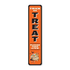 May include: Orange and black metal sign with the text "Trick or Treat" and "Please take a few". The sign features a cartoon illustration of a bag overflowing with sweets.