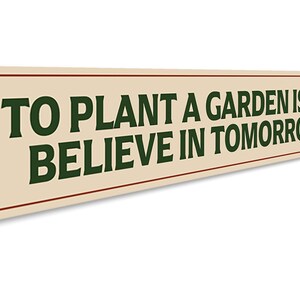 a sign that says to plant a garden is to believe in tomorrow