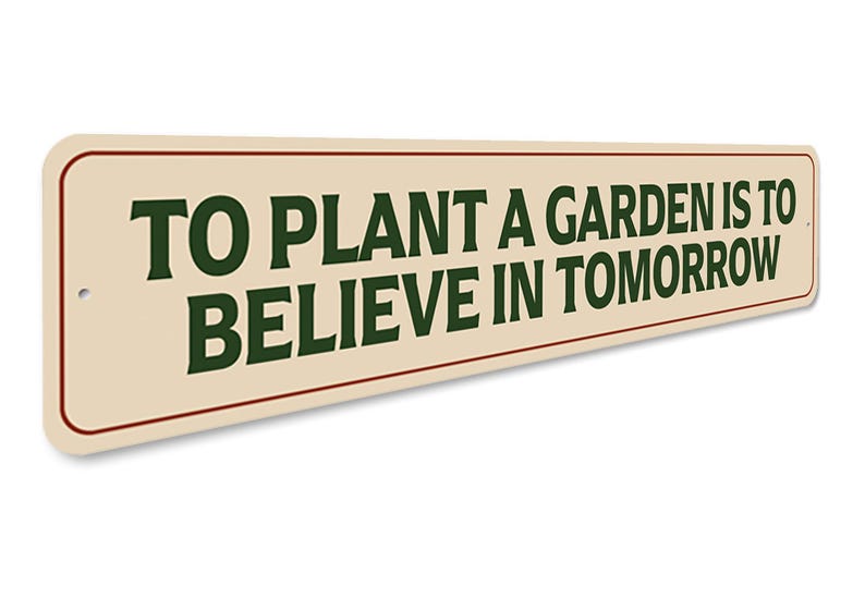 a sign that says to plant a garden is to believe in tomorrow