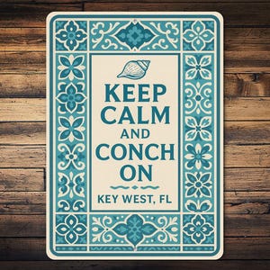 May include: Rectangular sign with a cream background and teal border featuring floral and seashell designs. The sign reads "KEEP CALM AND CONCH ON" with "KEY WEST, FL" below. The sign is on a wooden background.