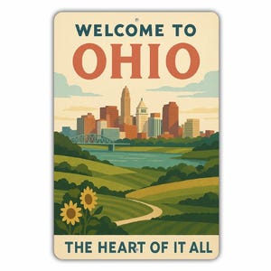 May include: A rectangular metal sign with the words "WELCOME TO OHIO" in teal and orange. The sign features a stylized illustration of a cityscape, a river, and rolling green hills with sunflowers. The text "THE HEART OF IT ALL" is at the bottom.