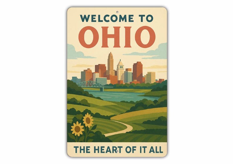 May include: A rectangular metal sign with the words "WELCOME TO OHIO" in teal and orange. The sign features a stylized illustration of a cityscape, a river, and rolling green hills with sunflowers. The text "THE HEART OF IT ALL" is at the bottom.
