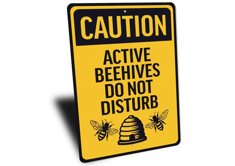 a yellow caution sign with a picture of a beehive