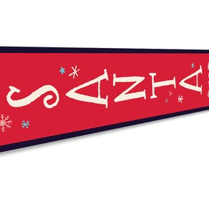 May include: Red metal sign with white text that reads "Santa Stop Here". The sign has a white arrow pointing to the right and snowflakes in blue and white.