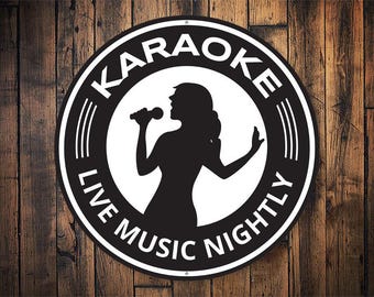 May include: Black and white round sign with the text "Karaoke Live Music Nightly" and a silhouette of a person singing into a microphone.