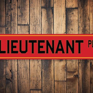 May include: Red and yellow sign with the text "LIEUTENANT PL" in black letters.