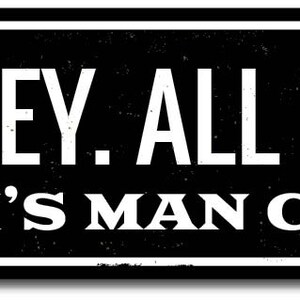 May include: Black and white sign with the text "ALL HOCKEY. ALL THE TIME. JOSH'S MAN CAVE" on a black background.