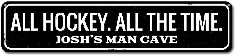 May include: Black and white sign with the text "ALL HOCKEY. ALL THE TIME. JOSH'S MAN CAVE" on a black background.