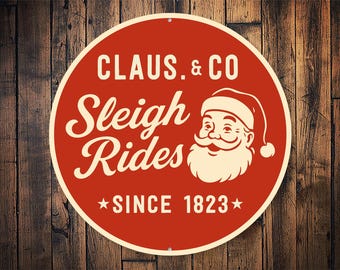Claus & Co Sleigh Rides Sign • Vintage Santa Christmas Decor • Retro Holiday Wall Art • Farmhouse Christmas Metal Sign • Santa Wall Plaque