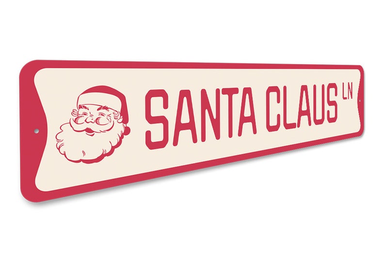 Op de afbeelding: Een rood en wit metalen bord met een afbeelding van de kerstman en de tekst "SANTA CLAUS LN".