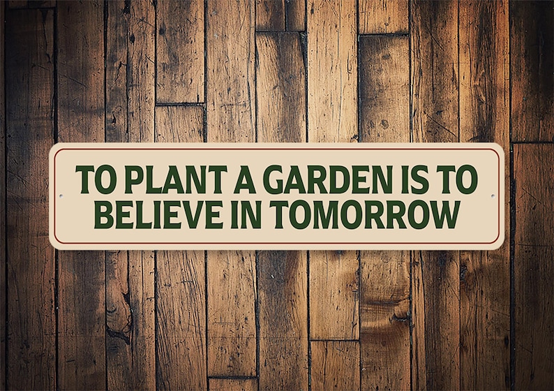 a sign that says to plant a garden is to believe in tomorrow
