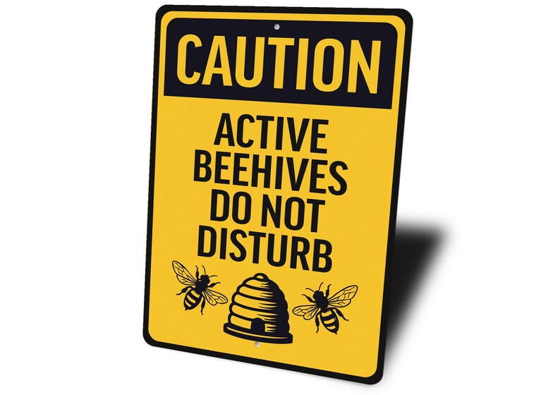 a yellow caution sign that says, active beehives do not disturb