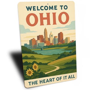 May include: A rectangular sign with the text "WELCOME TO OHIO" and "THE HEART OF IT ALL". The sign features a stylized illustration of a cityscape, river, bridge, and sunflowers.