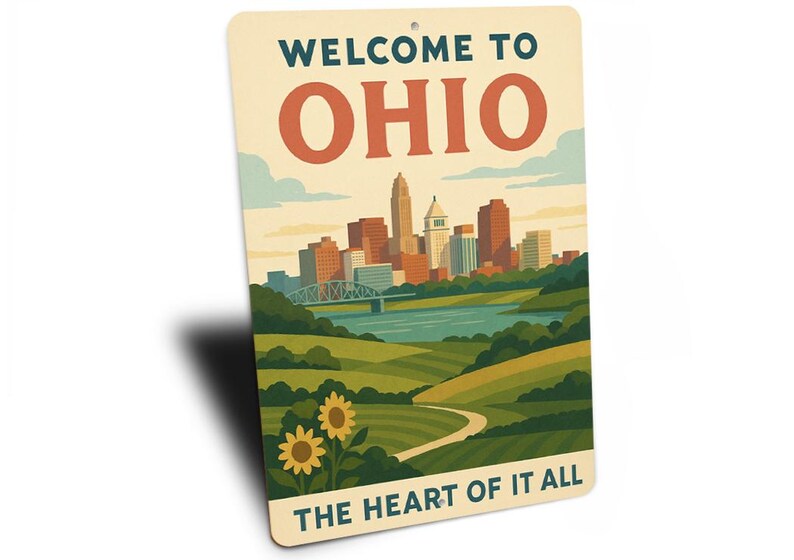 May include: A rectangular sign with the text "WELCOME TO OHIO" and "THE HEART OF IT ALL". The sign features a stylized illustration of a cityscape, river, bridge, and sunflowers.