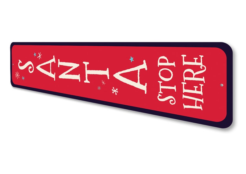 May include: Red metal sign with white text that reads "Santa Stop Here" with blue snowflake accents.