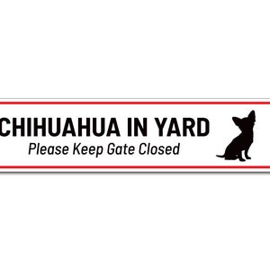May include: White sign with red border and black text that reads "Chihuahua in Yard Please Keep Gate Closed". A black silhouette of a chihuahua is on the right side of the sign.