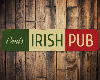 Puede incluir: Un letrero de estilo vintage con un esquema de color verde, blanco y rojo. El letrero dice "Paul's Irish Pub" en una fuente blanca.