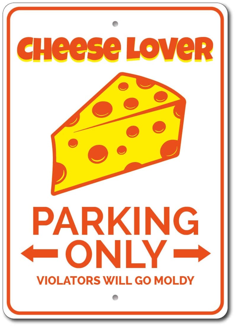 May include: A white metal sign with orange text and a cartoon image of a yellow wedge of cheese with orange holes. The sign reads "Cheese Lover Parking Only" and "Violators Will Go Moldy".